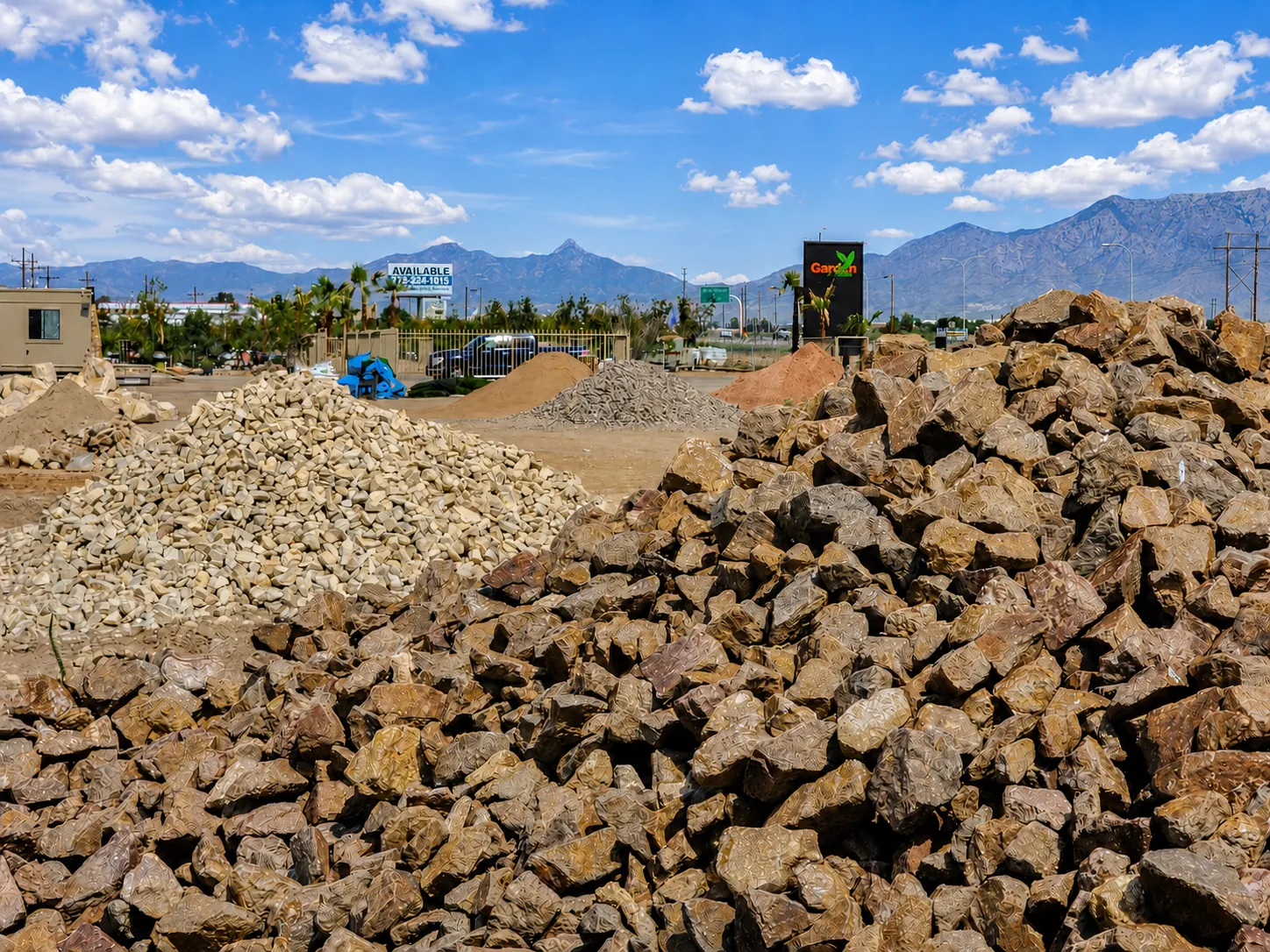 Piles of decorative rock and bulk landscape materials at the Garden Center of Las Cruces yard with the Organ Mountains in the background Piles of decorative rock and bulk landscape materials at the Garden Center of Las Cruces yard with the Organ Mountains in the background